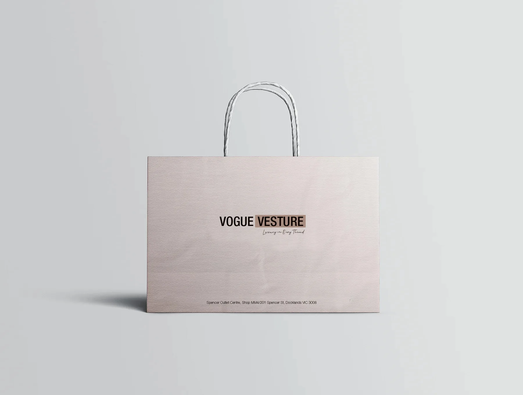 Wide blush Vogue Vesture luxury fashion shopping bag with minimal black branding.