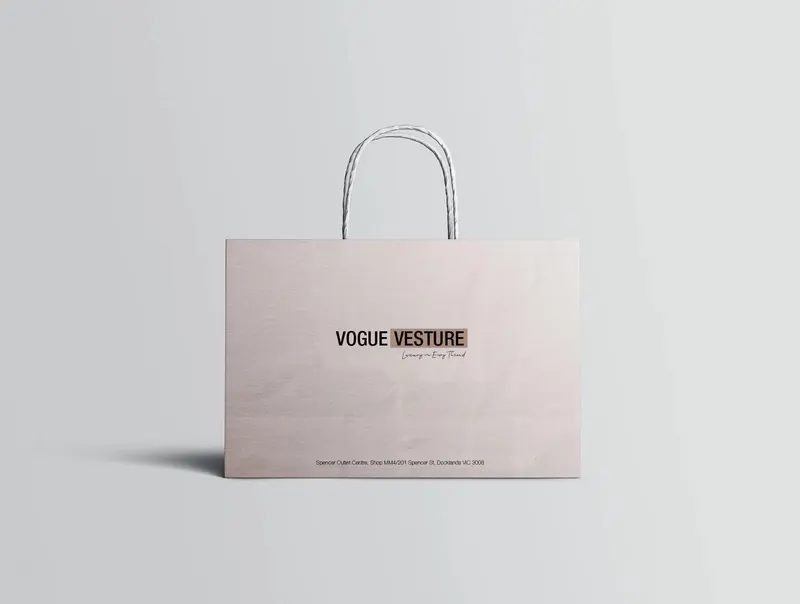 Wide blush Vogue Vesture luxury fashion shopping bag with minimal black branding.