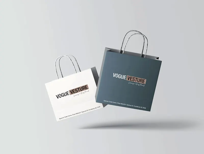 Two Vogue Vesture fashion shopping bags displayed in a floating mockup composition.