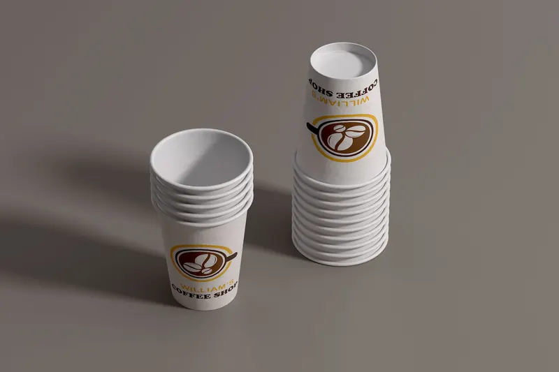 Stacks of William's Coffee Shop paper cups showing consistent logo application.